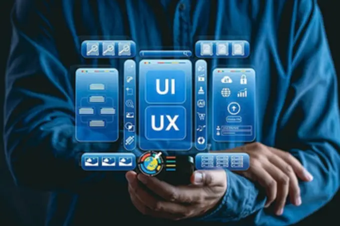 Hands holding layered UI and UX interface panels, illustrating a digital solution being built